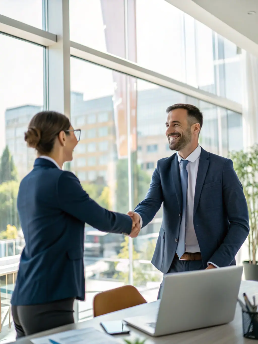A photo of a successful candidate shaking hands with a hiring manager at a Lithuanian company, symbolizing successful placement.